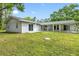 Expansive backyard featuring a covered patio, perfect for relaxing and enjoying the outdoor space at 346 Ranch Rd, Tarpon Springs, FL 34688