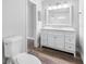 Bathroom featuring a white vanity, toilet and an open doorway leading to another room at 346 Ranch Rd, Tarpon Springs, FL 34688