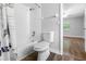 Bathroom features white tiling and fixtures, as well as a shower-tub combo at 346 Ranch Rd, Tarpon Springs, FL 34688