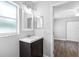 Bathroom with a modern vanity, mirror, and an adjacent bedroom with natural light at 346 Ranch Rd, Tarpon Springs, FL 34688