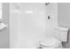 White tiled bathroom featuring a walk-in shower with a shower head and a white toilet at 346 Ranch Rd, Tarpon Springs, FL 34688
