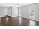 Bright bedroom with three windows and wood flooring with an open door leading to a bathroom at 346 Ranch Rd, Tarpon Springs, FL 34688