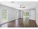 Bright bedroom with two windows, wood flooring and a sliding glass door for exterior access at 346 Ranch Rd, Tarpon Springs, FL 34688