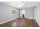 Spacious bedroom featuring wood-look floors, neutral paint, and an adjacent bathroom at 346 Ranch Rd, Tarpon Springs, FL 34688
