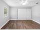 Bedroom with a ceiling fan, wood floors, and a sliding-door closet at 346 Ranch Rd, Tarpon Springs, FL 34688