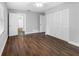 Bedroom with wood floors, white walls, a closet, and an ensuite bathroom at 346 Ranch Rd, Tarpon Springs, FL 34688