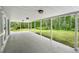 Large covered patio with an extended concrete floor and view of the lush backyard at 346 Ranch Rd, Tarpon Springs, FL 34688