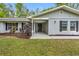 A close exterior view of this home featuring manicured landscaping and an inviting front porch at 346 Ranch Rd, Tarpon Springs, FL 34688