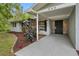 A closer view of this home's exterior with inviting front porch and well-kept landscaping at 346 Ranch Rd, Tarpon Springs, FL 34688