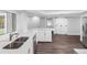 Kitchen with stainless steel appliances, stone countertops and dark floors with a view to the dining area at 346 Ranch Rd, Tarpon Springs, FL 34688