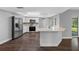 Bright open-concept kitchen, featuring stainless steel appliances, modern white cabinets, with a breakfast bar at 346 Ranch Rd, Tarpon Springs, FL 34688