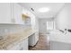 Laundry room featuring washer, dryer, and counter space, offering convenience and functionality at 346 Ranch Rd, Tarpon Springs, FL 34688