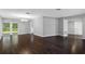 Spacious living room with wood flooring, chandelier lighting, and access to the backyard at 346 Ranch Rd, Tarpon Springs, FL 34688