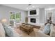 Comfortable living room with a stone fireplace, a large television, and sliding glass doors at 346 Ranch Rd, Tarpon Springs, FL 34688