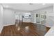 Living room with tile floor, kitchen, and sliding glass doors to outside, offering a seamless flow at 346 Ranch Rd, Tarpon Springs, FL 34688