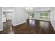 Open-plan living room features new floors, neutral walls, and lots of natural light at 346 Ranch Rd, Tarpon Springs, FL 34688