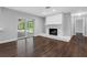 Open floor plan features a living room with a stone fireplace and sliding glass doors to the outdoors at 346 Ranch Rd, Tarpon Springs, FL 34688