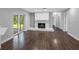Bright living room with a stone fireplace, wood floors, and sliding glass doors to the backyard at 346 Ranch Rd, Tarpon Springs, FL 34688