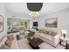 Living room showcases couches, an area rug, a coffee table, wall decor, and natural lighting at 346 Ranch Rd, Tarpon Springs, FL 34688