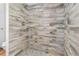 Tiled shower featuring attractive faux wood and a pebble floor at 346 Ranch Rd, Tarpon Springs, FL 34688