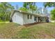 Side exterior showcasing the home's design, and well-maintained flower beds at 346 Ranch Rd, Tarpon Springs, FL 34688