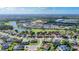 Picturesque aerial view of a residential community featuring a lake, golf course, and lush green landscapes at 3625 Gaviota Dr, Ruskin, FL 33573
