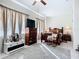 Cozy bedroom with a ceiling fan, decorative rocking chair, and a large dresser with a mounted TV at 3625 Gaviota Dr, Ruskin, FL 33573