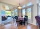 Cozy dining area with hardwood floors, an adjacent screened porch, and natural light at 3625 Gaviota Dr, Sun City Center, FL 33573