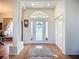 Bright and welcoming foyer featuring hardwood floors, a decorative glass door, and recessed lighting at 3625 Gaviota Dr, Ruskin, FL 33573