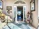 Inviting foyer with palm frond rug, decorative accents, and a glimpse into the living space at 3625 Gaviota Dr, Ruskin, FL 33573