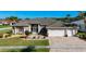 Charming home boasts a three-car garage and meticulously maintained front yard and walkway with lush landscaping at 3625 Gaviota Dr, Ruskin, FL 33573