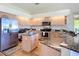 Spacious kitchen with granite counters, stainless appliances, kitchen island and hardwood flooring at 3625 Gaviota Dr, Ruskin, FL 33573