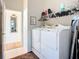 Bright laundry room boasts convenient washer, dryer, shelving and decor for efficient chores at 3625 Gaviota Dr, Ruskin, FL 33573