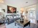 Comfortable living room with a luxurious leather couch and a decorative lion artwork above at 3625 Gaviota Dr, Ruskin, FL 33573