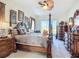Luxurious main bedroom with four-poster bed, hardwood furniture, and abundant natural light at 3625 Gaviota Dr, Ruskin, FL 33573