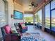 Screened patio with outdoor seating, nautical decor, and a ceiling fan at 3625 Gaviota Dr, Ruskin, FL 33573