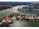 Waterfront homes with private docks, boats, lush landscaping, and waterway views on a sunny day at 366 La Hacienda Dr, Indian Rocks Beach, FL 33785