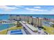 Stunning aerial view of condo buildings featuring waterfront views, tennis courts, and convenient parking at 4725 Cove Cir # 302, St Petersburg, FL 33708