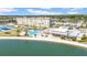 Waterfront community featuring a swimming pool, clubhouse, and tennis courts, all overlooking a picturesque waterway at 4725 Cove Cir # 302, St Petersburg, FL 33708