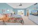 Bright bedroom with balcony access, TV, and coastal decor at 4725 Cove Cir # 302, St Petersburg, FL 33708