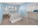 Comfortable bedroom with carpeted floors, ample natural light, and closet provides a restful retreat at 4725 Cove Cir # 302, St Petersburg, FL 33708