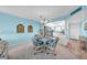 A dining room with a view to the kitchen, light blue walls, and a round table with four chairs at 4725 Cove Cir # 302, St Petersburg, FL 33708