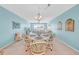 Bright dining room features a decorative chandelier and large windows with water views at 4725 Cove Cir # 302, St Petersburg, FL 33708