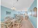 Cozy dining area featuring an elegant chandelier and comfortable seating, perfect for enjoying meals with a view at 4725 Cove Cir # 302, St Petersburg, FL 33708