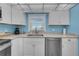 Well-lit kitchen with white cabinets and stainless steel appliances at 4725 Cove Cir # 302, St Petersburg, FL 33708