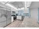 Bright kitchen featuring stainless steel appliances, white cabinetry, and a lovely countertop island at 4725 Cove Cir # 302, St Petersburg, FL 33708