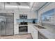 Bright kitchen with stainless steel appliances, white cabinetry, and granite countertops, creating a modern and inviting space at 4725 Cove Cir # 302, St Petersburg, FL 33708