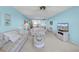 Bright living room with blue walls, ceiling fan and comfortable seating arrangements and an open-concept kitchen at 4725 Cove Cir # 302, St Petersburg, FL 33708