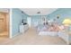 Spacious main bedroom featuring a comfortable bed, dresser, television, ceiling fan, and private bathroom at 4725 Cove Cir # 302, St Petersburg, FL 33708