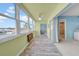 A beautiful sun room with plenty of windows and access to the balcony, offering stunning views of the outdoors at 4725 Cove Cir # 302, St Petersburg, FL 33708